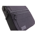A man stands by his bike with the Throttle Twist Hybrid Saddlebag/Backpack—versatile motorcycle luggage that easily converts into a backpack. Text: "Convertible Saddlebags/Backpack." Brand: Throttle Twist.