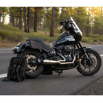 A man stands by his bike with the Throttle Twist Hybrid Saddlebag/Backpack—versatile motorcycle luggage that easily converts into a backpack. Text: "Convertible Saddlebags/Backpack." Brand: Throttle Twist.