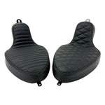 Two black motorcycle seats from Sully's Customs—a hardtail saddle with horizontal stitching and the Cobra Seat for Hardtail with a diamond quilted design—are shown from above, each built on a sturdy steel pan.