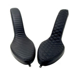 Two black motorcycle seats from Sully's Customs—a hardtail saddle with horizontal stitching and the Cobra Seat for Hardtail with a diamond quilted design—are shown from above, each built on a sturdy steel pan.