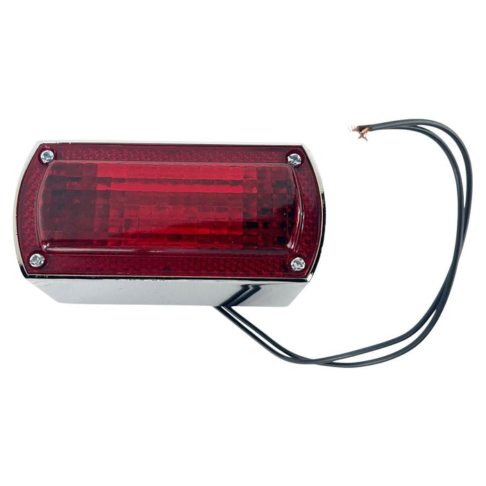 The Box Style Chopper Tail Light by Wyatt Gatling features a rectangular red LED brake lamp encased in a chrome housing, complete with two black electrical wires extending from it.