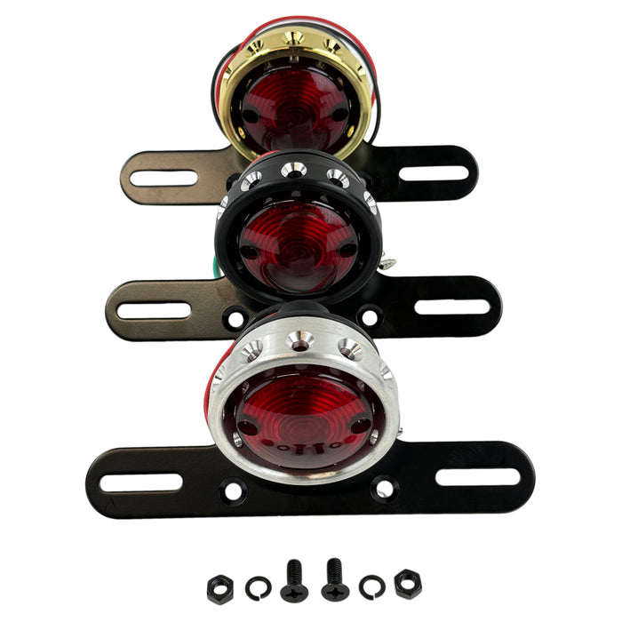 The Mid-USA Vintage Drilled Tail Light by Mid-USA features a round red lens in an aluminum housing, mounted on a black bracket with exposed electrical wires at the back.