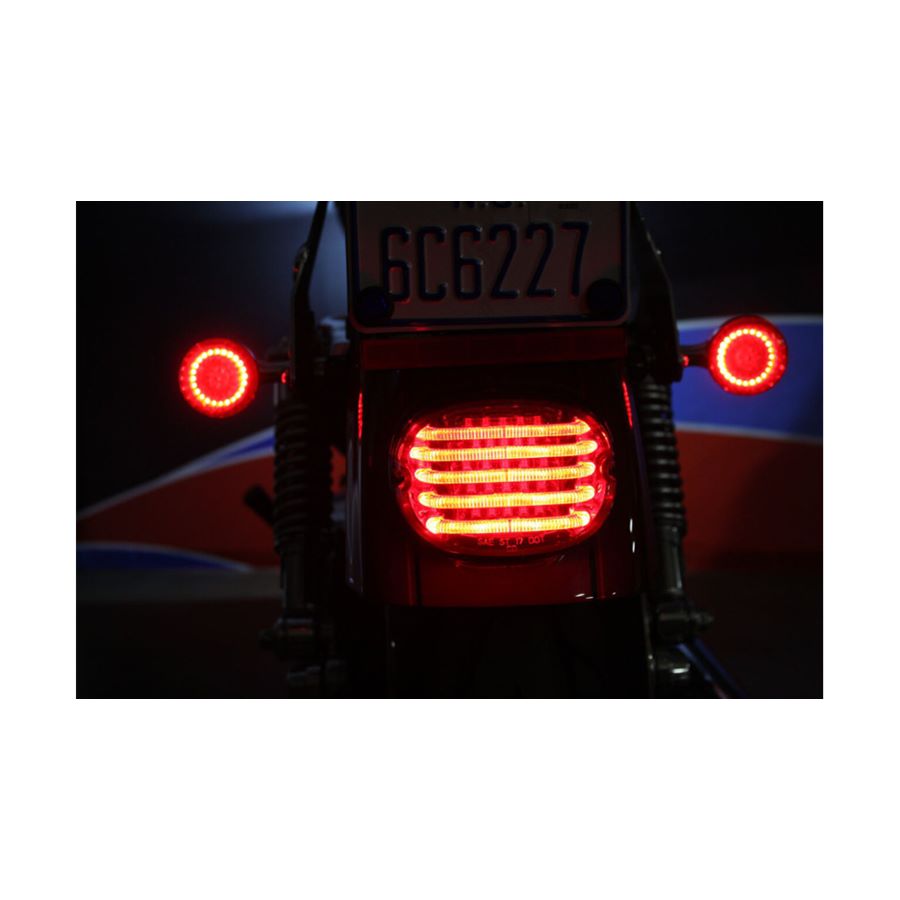 A close up of a ProBEAM Low Profile LED Taillight For Harley 1999-2024 - Smoke (No License Light) by Custom Dynamics on a red Harley motorcycle.