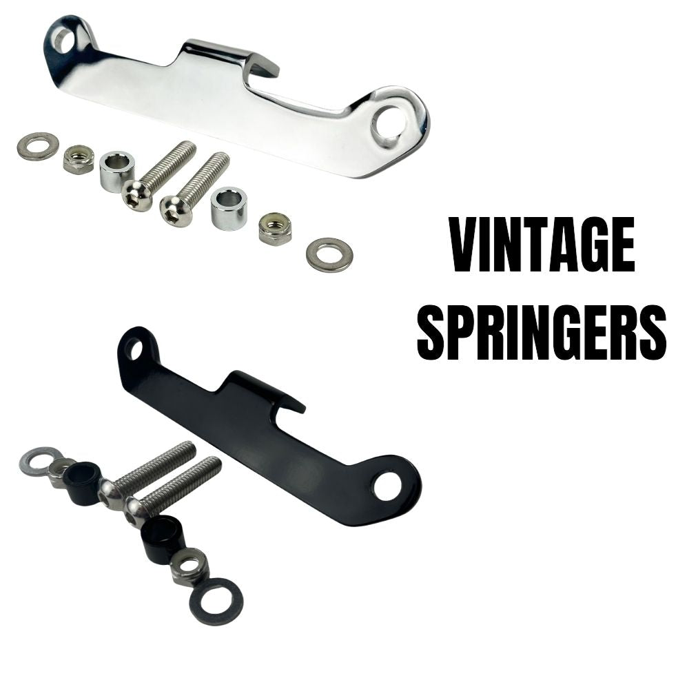 The TC Bros. Vintage Springer Headlight Mounting Bracket Chrome for Harley Davidson comes with a metal bracket featuring two holes, along with two screws, washers, and nuts. Ideal for securely mounting your vintage Springer headlight on your Harley Davidson.