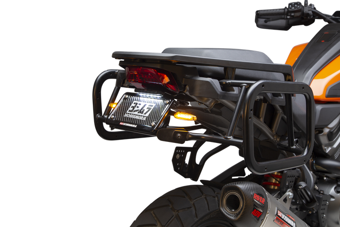 Close-up of a Harley-Davidson Pan America equipped with a Yoshimura Fender Eliminator Kit, featuring the taillight, license plate holder with “Yoshimura” branding, and dual round signal lights.