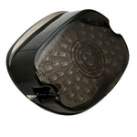 The Moto Iron® LED Laydown Squareback Light for 1973-1998 Harley-Davidson offers a circular pattern, shown unlit and illuminated in red, yellow, and white, with integrated turn signals for enhanced visibility.
