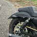 Black metal TC Bros. License Plate Relocation Bracket for 2010-2022 Harley-Davidson Sportster with mounting hardware for saddlebag installation.