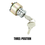 Three Moto Iron® metal ignition switches, including the Moto Iron Universal Ignition Switch, are arranged diagonally on a white background. Each switch displays exposed terminals and comes with attached keys.