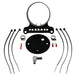 The Moto Iron® Single Gauge Mounting Kit for Harley-Davidson—Black includes a 4" gauge mount, bracket, hose clamps, zip ties, electrical connectors, fitting, and a round black plate arranged on a white background.