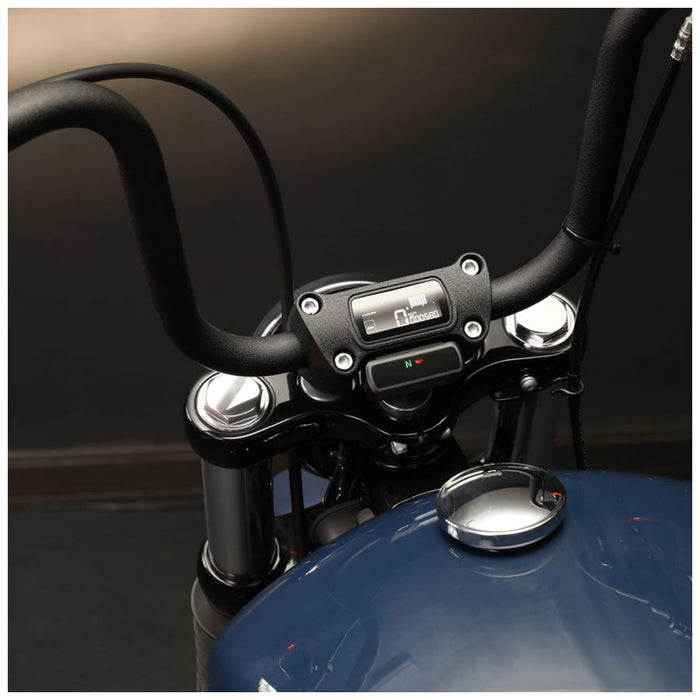 A digital car dashboard display shows a speed of 99 km/h along with engine and battery status indicators. The KOSO D2 Multifunction Meter 2018-2024 Harley M8 Softail also features a gear indicator and a programmable shift light, all branded with the Koso logo in the bottom right corner.