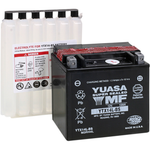 Three Yuasa YTX14/YTX14L batteries, including two black sealed AGM batteries in the foreground, and one electrolyte container with visible warning labels in the background.