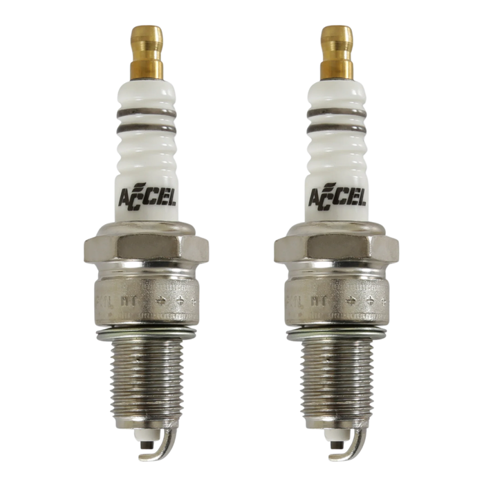 Four Accel Spark Plugs for Harley-Davidson Shovelhead and Evolution engines, from the Accel brand, are displayed in two pairs on a white background, showing noticeable differences in their metal tips.