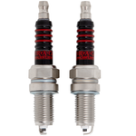 Two Drag Specialties Spark Plugs for Harley-Davidson Twin Cam and Sportster Evolution with gold-colored metal bases and black insulators with red rings.