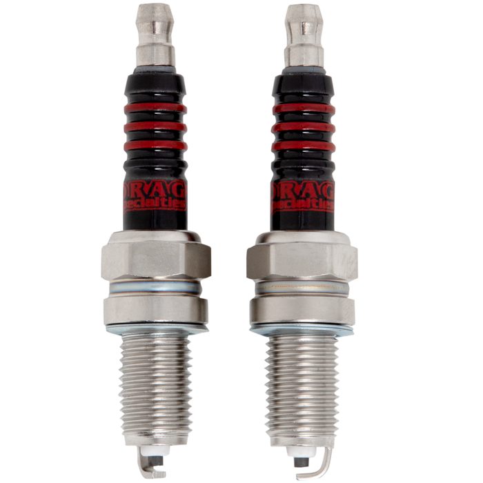 Two Drag Specialties Spark Plugs for Harley-Davidson Twin Cam and Sportster Evolution with gold-colored metal bases and black insulators with red rings.