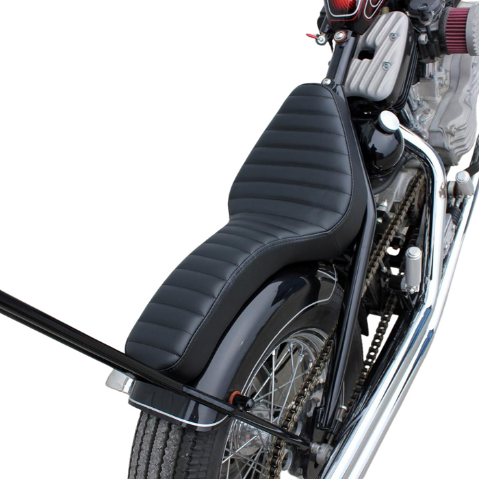 Two black, ribbed TC Bros. Cobra Hardtail Seats are shown, one installed on a motorcycle—ideal for Sportster hardtails or anyone wanting the classic look of a TC Bros. Cobra chopper seat.