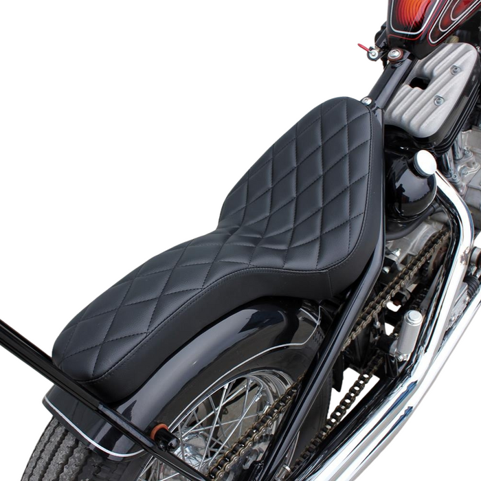 Two black, ribbed TC Bros. Cobra Hardtail Seats are shown, one installed on a motorcycle—ideal for Sportster hardtails or anyone wanting the classic look of a TC Bros. Cobra chopper seat.