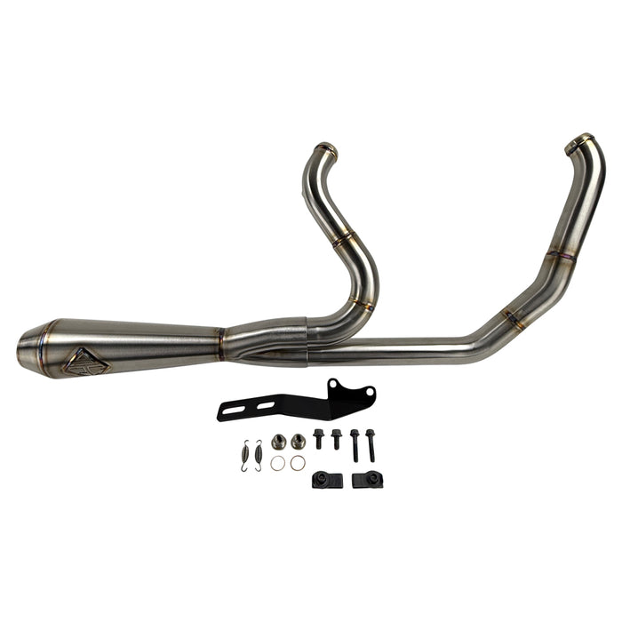 The SP Concepts Lane Splitter Exhaust for M8 Softail w/o Factory Bags—Stainless, features a 2-into-1 design, visible welds, and brand logo emblem, displayed on a workshop surface.