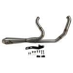 The SP Concepts Lane Splitter Exhaust for M8 Softail w/o Factory Bags—Stainless, features a 2-into-1 design, visible welds, and brand logo emblem, displayed on a workshop surface.