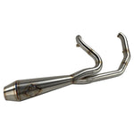 The SP Concepts Lane Splitter Exhaust for M8 Softail w/o Factory Bags—Stainless, features a 2-into-1 design, visible welds, and brand logo emblem, displayed on a workshop surface.