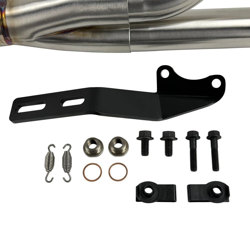 The SP Concepts Lane Splitter Exhaust for M8 Softail w/o Factory Bags—Stainless, features a 2-into-1 design, visible welds, and brand logo emblem, displayed on a workshop surface.