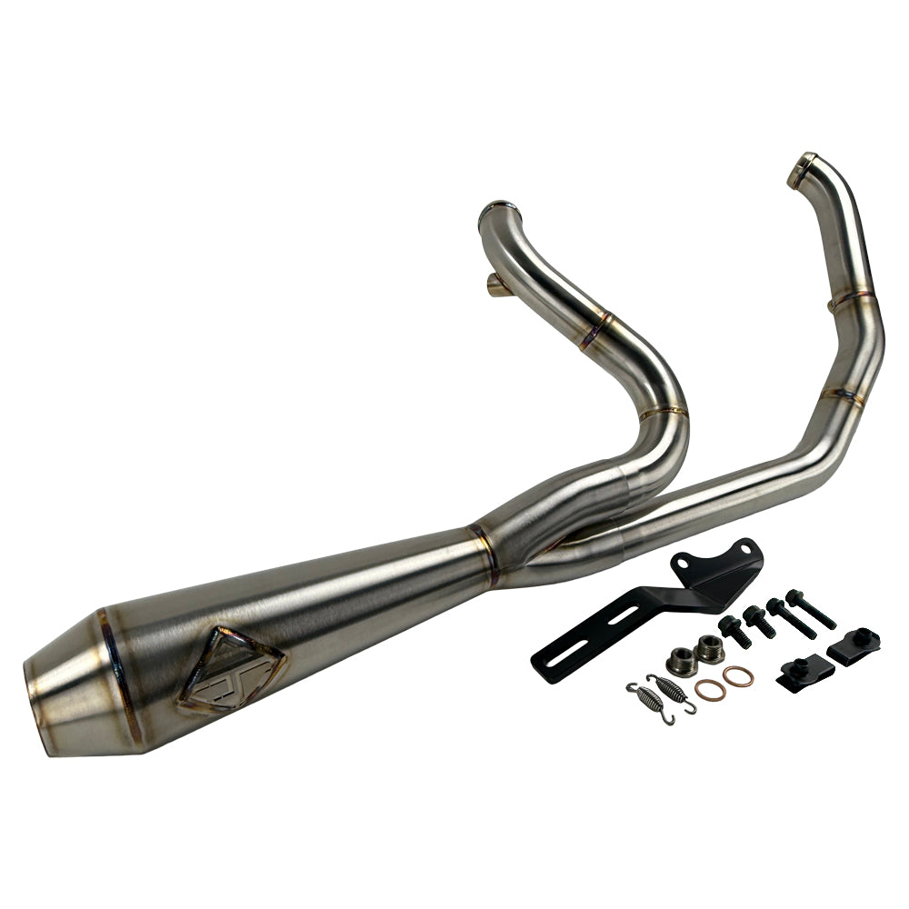 The SP Concepts Lane Splitter Exhaust for M8 Softail w/o Factory Bags—Stainless, features a 2-into-1 design, visible welds, and brand logo emblem, displayed on a workshop surface.