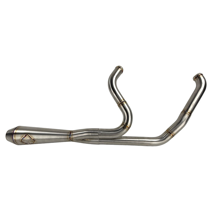The SP Concepts Lane Splitter Exhaust for Harley Touring 2017-2025 – Stainless, with visible welds, sits on a workbench beside an American flag welding helmet—ready to upgrade your ride in style.