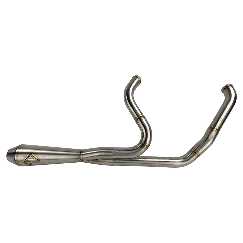 The SP Concepts Lane Splitter Exhaust for Harley Touring 2017-2025 – Stainless, with visible welds, sits on a workbench beside an American flag welding helmet—ready to upgrade your ride in style.