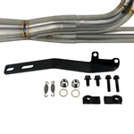 The SP Concepts Lane Splitter Exhaust for Harley Touring 2017-2025 – Stainless, with visible welds, sits on a workbench beside an American flag welding helmet—ready to upgrade your ride in style.