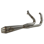 The SP Concepts Lane Splitter Exhaust for Harley Touring 2017-2025 – Stainless, with visible welds, sits on a workbench beside an American flag welding helmet—ready to upgrade your ride in style.