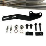 The SP Concepts Lane Splitter Exhaust for 2006-2017 Harley-Davidson Dyna features visible welds and a hexagonal logo plate, showcased on a workshop table.