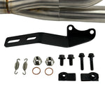 The SP Concepts Lane Splitter Exhaust for 2006-2017 Harley-Davidson Dyna features visible welds and a hexagonal logo plate, showcased on a workshop table.