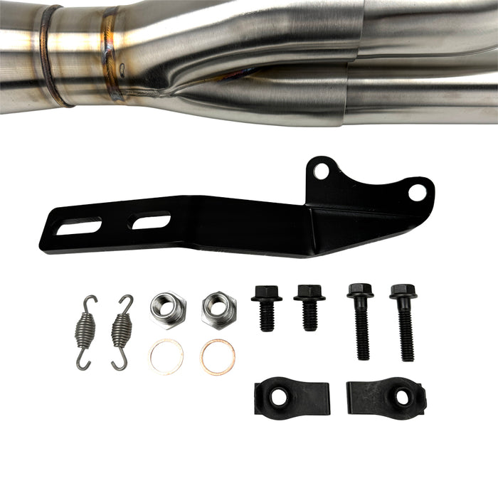 An SP Concepts Big Bore Exhaust 06-17 Dyna (stainless) motorcycle parked in a garage.