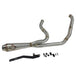 A custom SP Concepts Lane Splitter Exhaust for Harley-Davidson Dyna 1999-2005 lies on a workbench with welded joints; an American flag welding helmet is visible in the background. Stainless construction, ideal for exhaust builds.