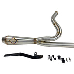 A custom SP Concepts Lane Splitter Exhaust for Harley-Davidson Dyna 1999-2005 lies on a workbench with welded joints; an American flag welding helmet is visible in the background. Stainless construction, ideal for exhaust builds.