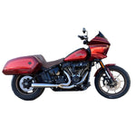 A red motorcycle with a Bassani Road Rage III 2-into-1 Stainless Exhaust 2018-21 FLSB, 2022-2024 FXL parked in front of a garage.