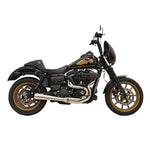 A black Harley-Davidson Dyna with gold wheels, raised front fairing, and a gold winged tank emblem is shown in side profile, featuring the Bassani Greg Lutzka 2-into-1 Stainless Exhaust for Dyna 1991-2017.