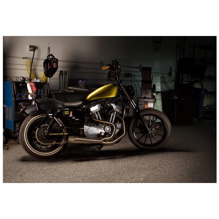 A Two Brothers Gen II Stainless 2 into 1 Exhaust for Harley Sportster 2014-2022 is parked in a garage.