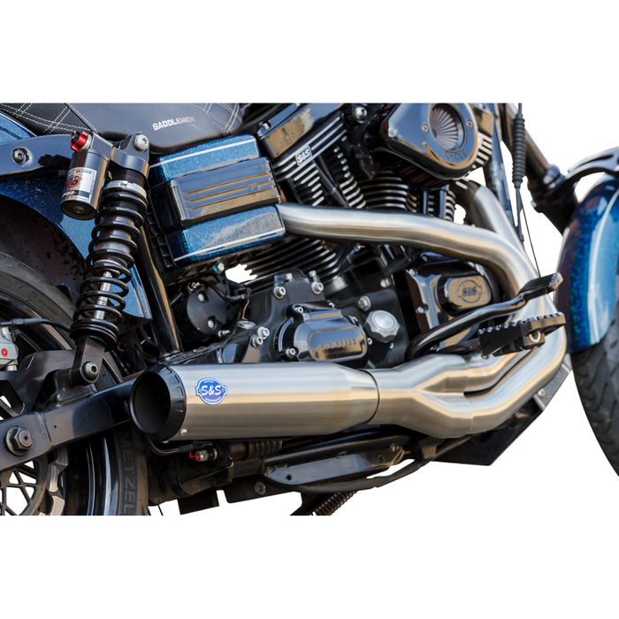 A blue and black cruiser with a V-twin engine, black seat, tall handlebars, and an S&S Cycle Qualifier 2-into-1 Exhaust System for 2006-2017 Harley-Davidson Dyna, viewed from the side on a white background.