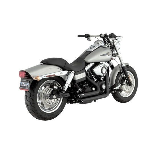 A silver motorcycle with a Vance & Hines Short Shots Exhaust System 06-09 Fat bob, Dyna, Low, Wide & Super Glide - Black on a white background.