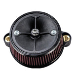 Close-up of a black circular mechanical component with a central screw and four spokes, two metal mounting brackets, and a red ribbed filter around its perimeter, resembling the Stealth Air Cleaner Kit - Black Cover - For 23 CVO Road Glide & 24+ Touring often seen on Road Glide models by S&S Cycle.