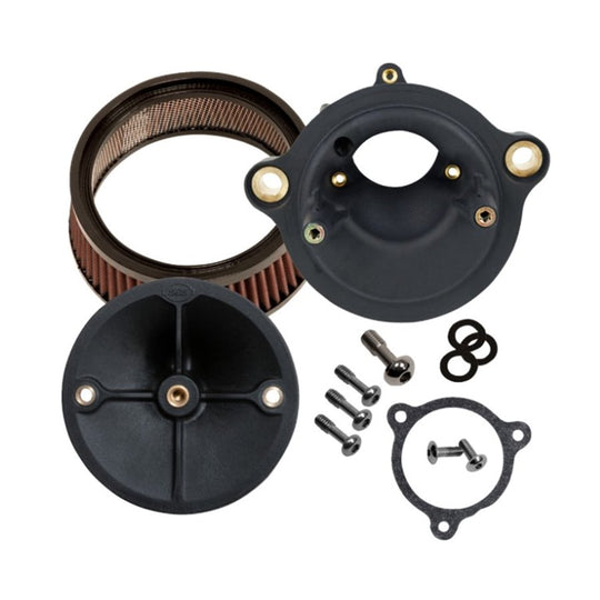 Close-up of a black circular mechanical component with a central screw and four spokes, two metal mounting brackets, and a red ribbed filter around its perimeter, resembling the Stealth Air Cleaner Kit - Black Cover - For 23 CVO Road Glide & 24+ Touring often seen on Road Glide models by S&S Cycle.