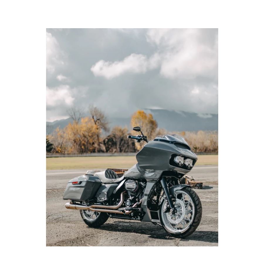 The SP Concepts Full Length Turnpike Works Edition for Harley '17-'24 M8 Touring headers and exhaust pipes made of stainless steel are neatly arranged on the warehouse floor, surrounded by shelves and boxes in the background.