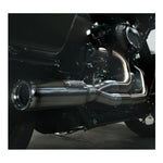 The Fab 28 Stainless Exhaust for 2017-Up Harley-Davidson Touring is shown in front of a wooden American flag with a bull design engraved on the blue field.