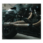 The Fab 28 Stainless Exhaust for 2018-Up Harley-Davidson Softail by Fab 28 is shown in front of a wooden American flag featuring a horse design, ideal for Harley-Davidson Softail enthusiasts.