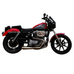 An SP Concepts Lanesplitter Exhaust for Harley Davidson Sportster (1986-2003) is showcased on a textured surface with intricate curves. Nearby, an American flag-patterned helmet hints at the increased torque this meticulously welded stainless steel product promises.