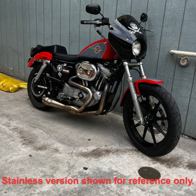 An SP Concepts Lanesplitter Exhaust, featuring their sleek logo, lies on the concrete alongside stainless steel headers, perfectly tailored for a black Harley Davidson Sportster (1986-2003), transforming it into an exhilarating ride.