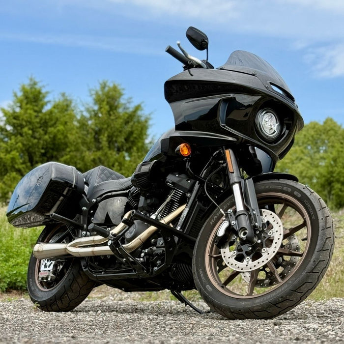 TC Bros. 2-into-1 Stainless Exhaust System for 2018-Up Harley-Davidson Softail by TC Bros., displayed with various Harley-Davidson Softail exhaust pipes in the background.