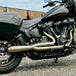 TC Bros. 2-into-1 Stainless Exhaust System for 2018-Up Harley-Davidson Softail by TC Bros., displayed with various Harley-Davidson Softail exhaust pipes in the background.