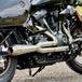 TC Bros. 2-into-1 Stainless Exhaust System for 2018-Up Harley-Davidson Softail by TC Bros., displayed with various Harley-Davidson Softail exhaust pipes in the background.