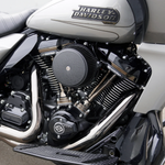 Close-up of a Harley-Davidson motorcycle engine, showcasing Milwaukee-Eight metal components, signature Harley-Davidson branding, the Arlen Ness Big Sucker Stage 1 Air Cleaner for 2023-Up Big Twin models, and part of the bike’s seat and frame.